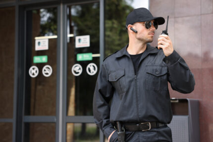 bodyguard with earpiece using walkie talkie near b 2026 07 24 00 28 34 utc