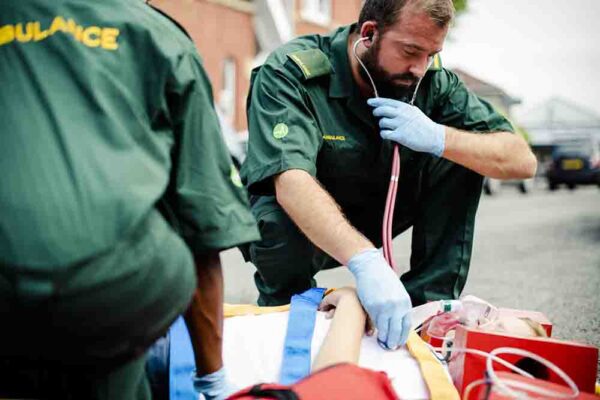 Paramedic team rescuing a young critical patient